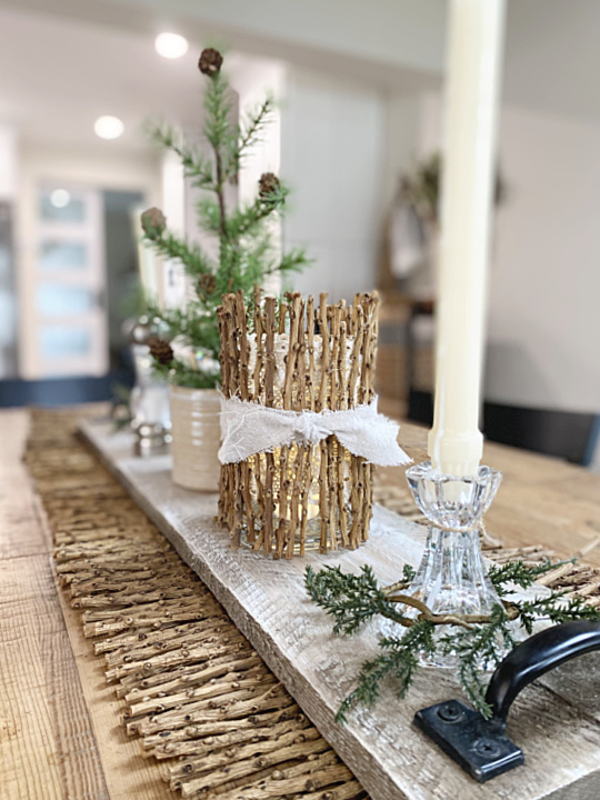 kitchen table with stick runner, tree and candle vase