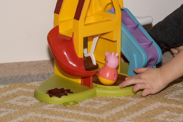 manually turning the roundabout on the playhouse to turn peppa round