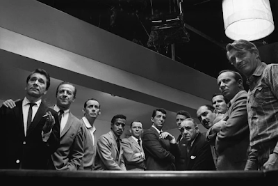 black and white photograph of the cast of the 1960 movie "Oceans 11" around a pool table