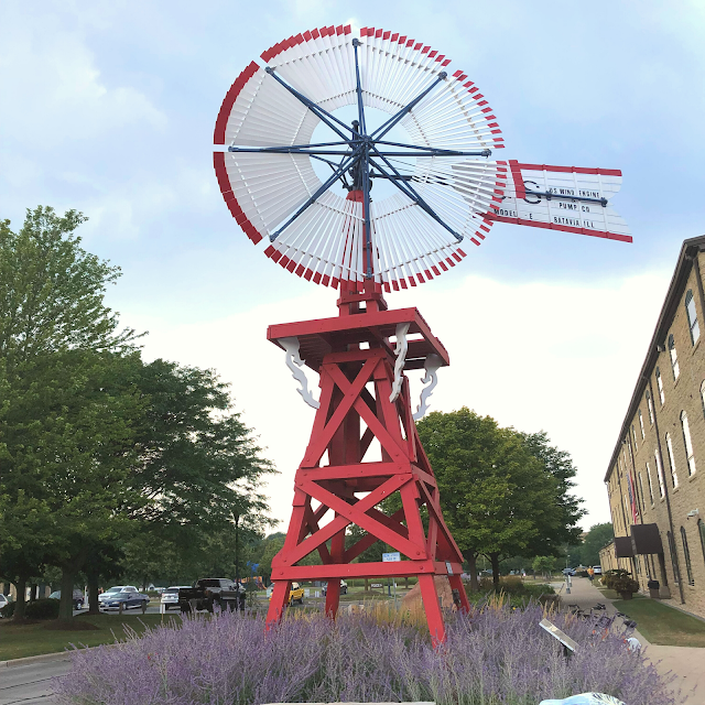 Windmills stand tall along the riverwalk in Batavia, Illinois.