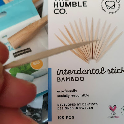 The Humble Co bamboo interdental sticks one held out of full packet