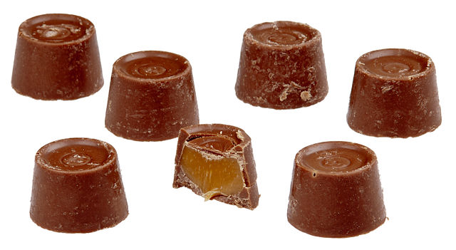 Eight Rolo chocolates, one cut in half.