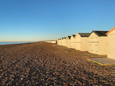 Goring beach huts in early morning sunshine