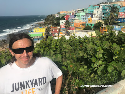 Jody Potter wearing a Junkyard Life tshirt stands overlooking La Perla area of Puerto Rico.