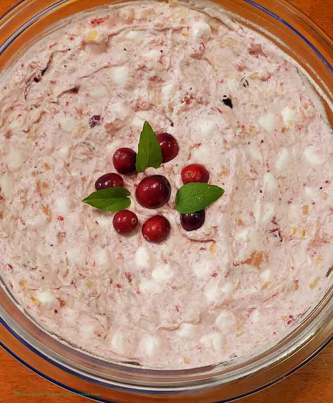 whole cranberries and cream fluffy side dish for the holiday in a glass bowl