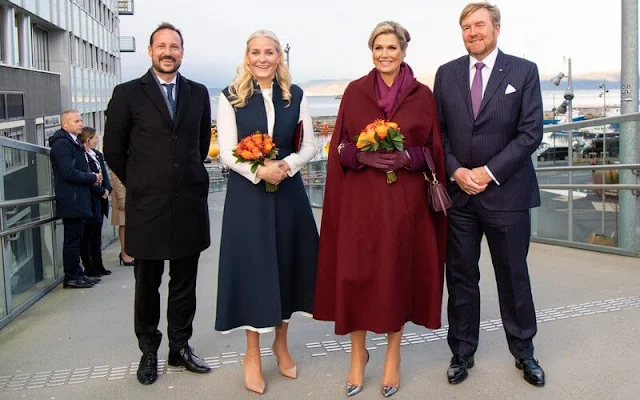 Queen Maxima wore Sirius wine-red coat by Claes Iversen. Crown Prince Haakon and Crown Princess Mette-Marit