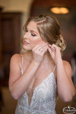 bride putting on earrings