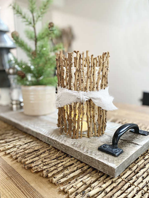 stick wrapped candle and tree on table