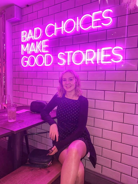 Girl in front of neon sign