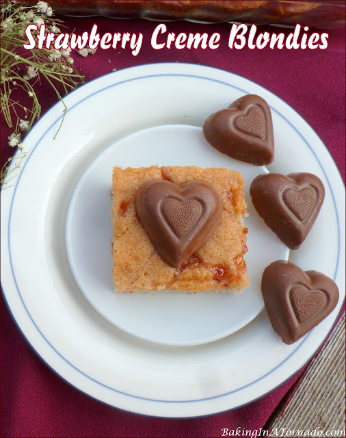 Strawberry Crème Blondies, impress your valentine with this strawberry swirled blondie topped with a strawberry crème heart. | recipe developed by www.BakingInATornado.com | #bake #dessert