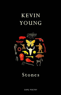 Book cover. Black with lots of different small shapes on - skull, butterfly, gun, mask, grenade, arm, toy soldier etc