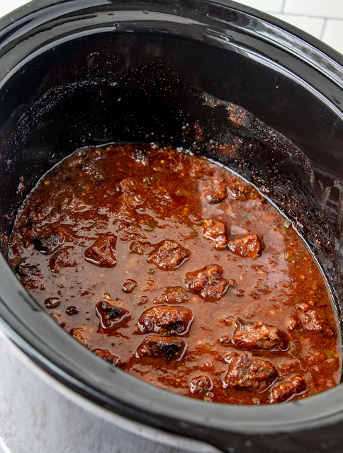 Beef and sauce in a slow cooker.