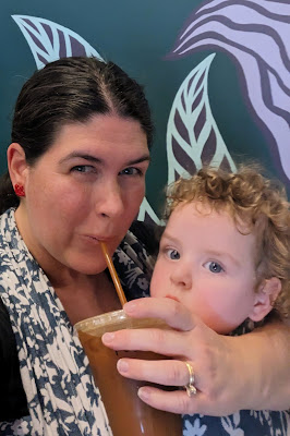 A woman with dark hair sips a pumpkin coffee at Hardline Coffee in Sioux City