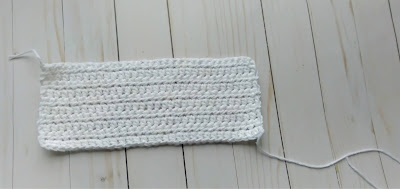 Crocheted flat cup cozy in white