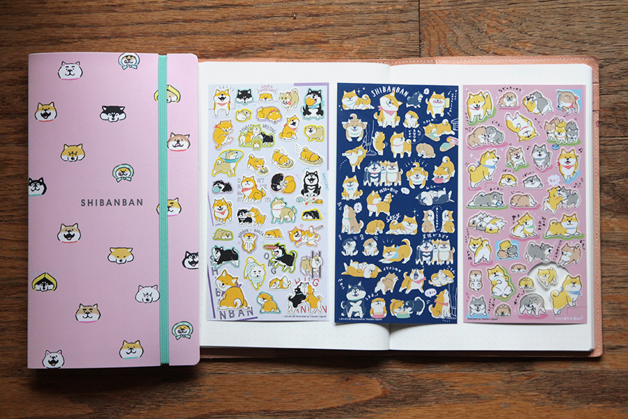 A photograph of a sticker organizer and three sheet stickers, all featuring Shibanban designs.