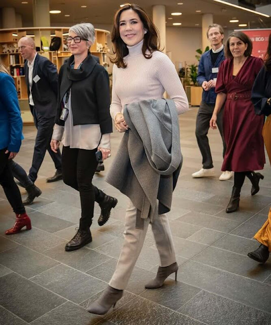 Crown Princess Mary wore a cashmere and wool blend cape coat by Massimo Dutti, and pink knit turtleneck sweater