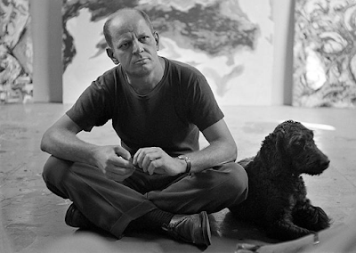 Jackson Pollock seated in his studio with his dog, East Hampton, 1953