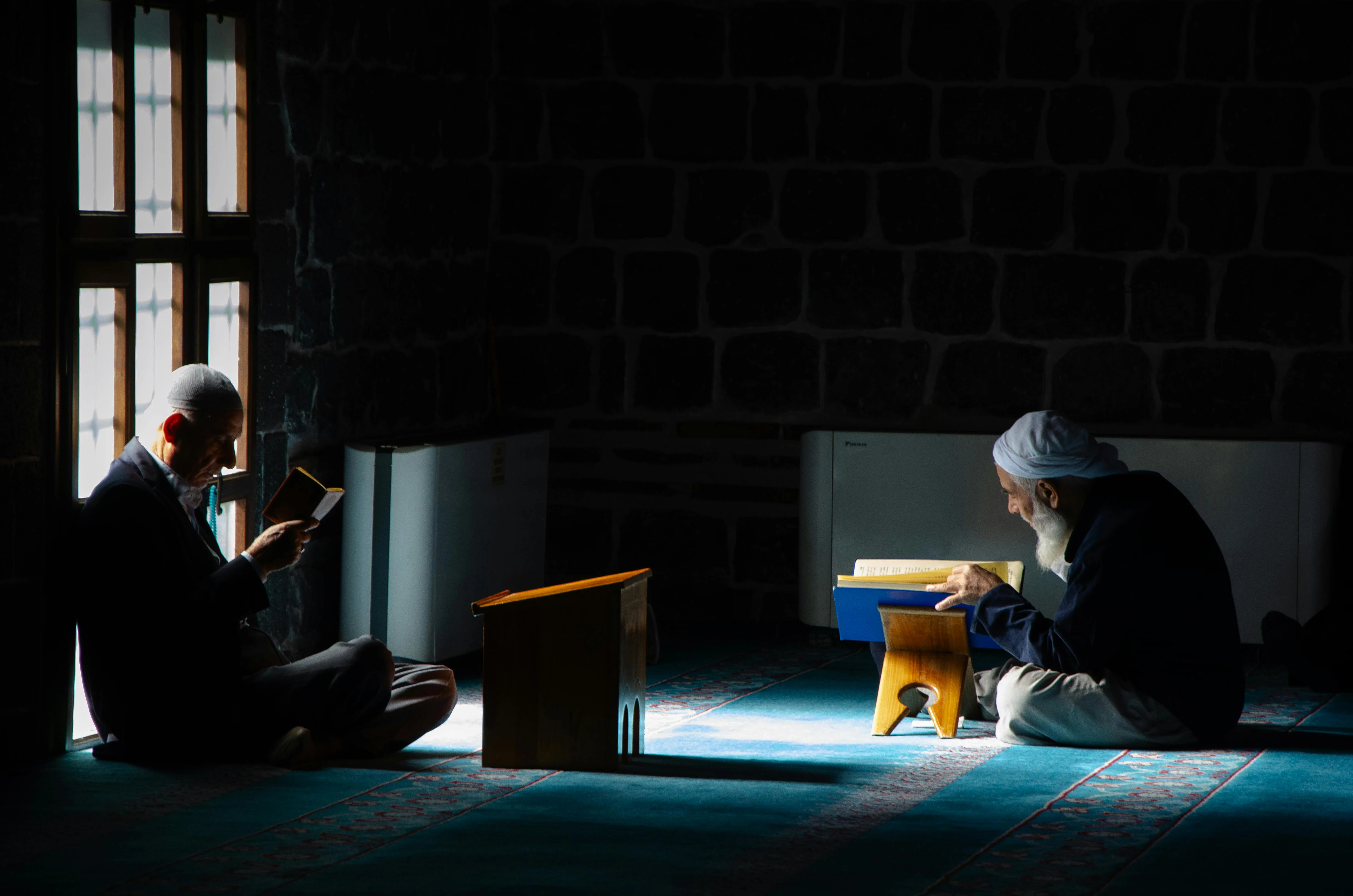Muslim's persons quietly reading the Holy Quran in a peaceful setting.