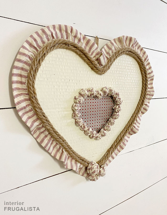 A handmade red ticking stripe heart wreath made with recycled materials.
