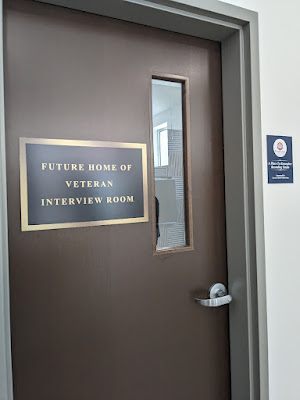 A door with a sign that indicates the room will serve as the veteran interview room