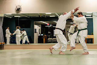 Two martial artists practicing jujitsu in Ann Arbor