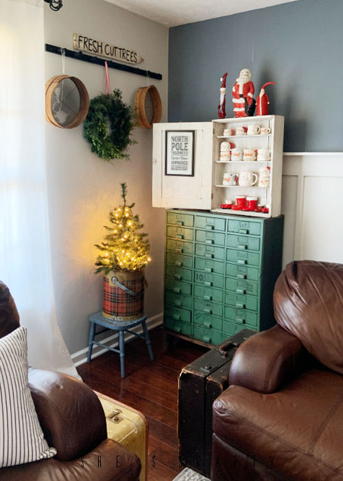 Home Tour Living Room green metal cabinet with santa mugs