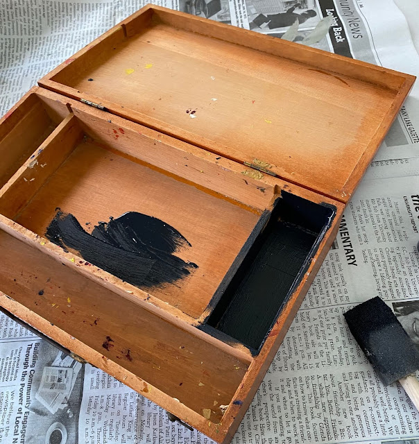 Photo of a vintage wooden artist paint case being painted with Caviar Dixie Belle Chalk Paint.