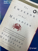 The Emperor of All Maladies, by Siddhartha Muknerjee, superimposed on Intermediate Physics for Medicine and Biology.