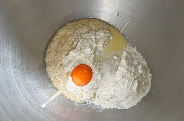 Adding the sourdough starter, egg yolk and salt with half of the flour