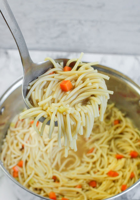 ladle of soup over the soup pot.