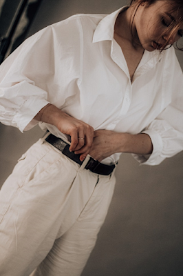 A Young Girl Wearing White Trouser, White Shirt and Black Leather Belt