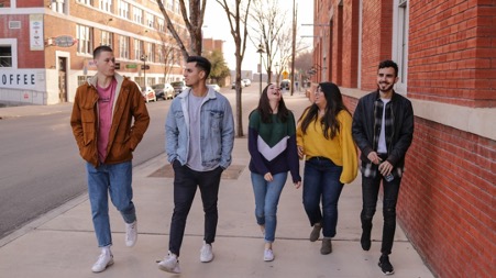 people walk down street