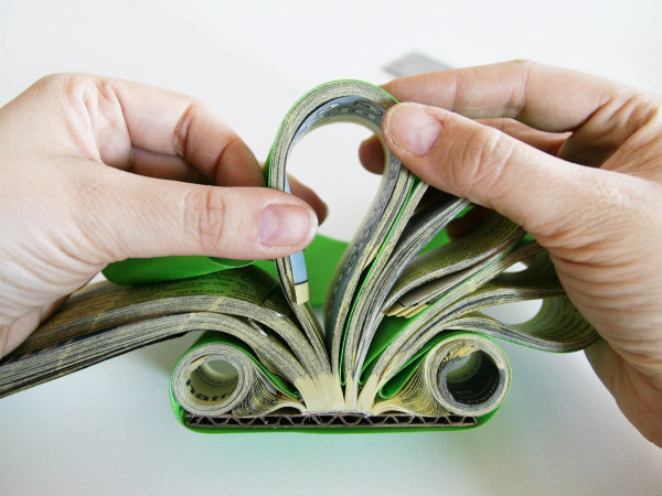 hands curving section of phone book letter holder