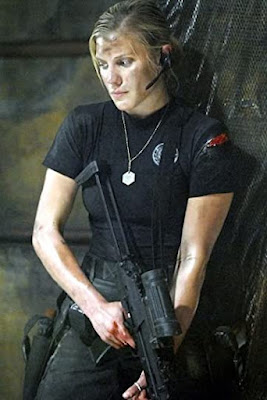 Katee Sackhoff looking grungy with a gun about to kick ass