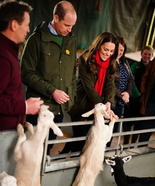 Kate Middleton wore a green long belted coat by Sportmax, and green woodcock advanced jacket by Seeland