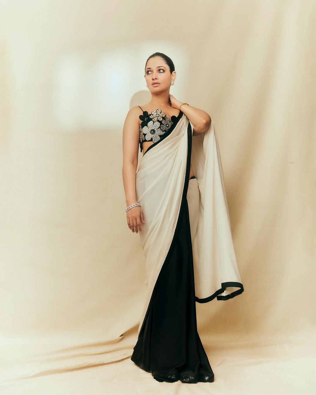 Milky Beauty Tamannaah Bhatia flaunts in a Floral Backless Blouse paired with a Black and White Saree