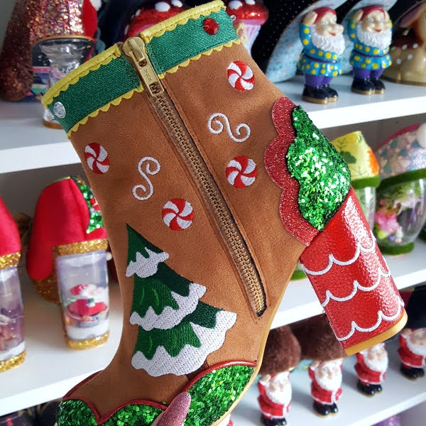 inner side of gingerbread themed ankle boot held in hand in shoe room