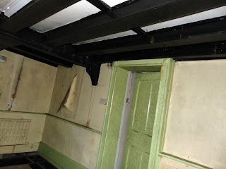 "inside an abandoned  tudor hall"