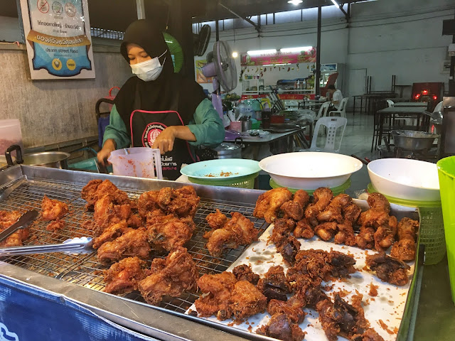 a street vendor sells fresh fried chicken in Hat Yai, Thailand