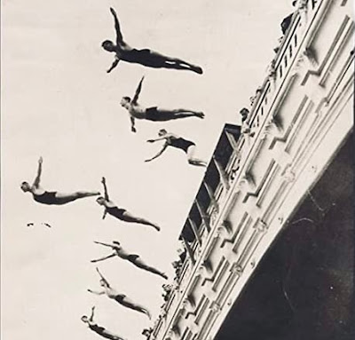Black and White Photograph of people swan diving off a bridge