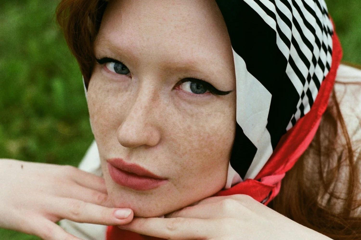 a close-up of a woman in a field