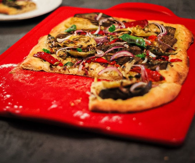 veggie pizza on red stone