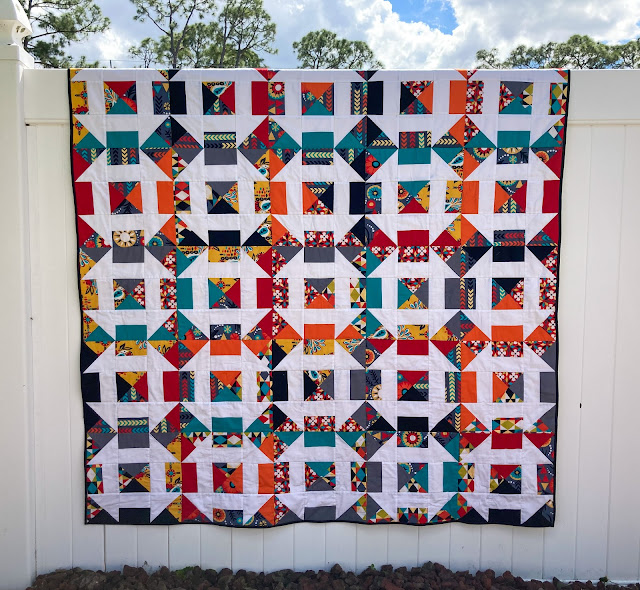 Bejeweled Churn Dash Quilt on the fence