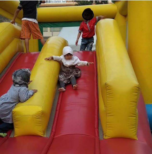 white bounce house with slide