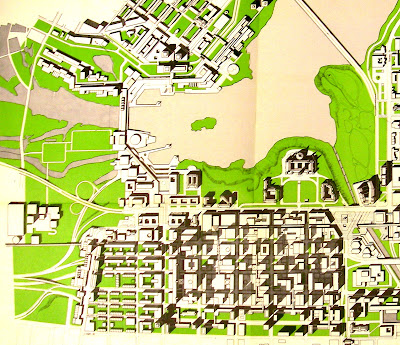 Overhead conceptual map of downtown Ottawa and its current and potential future buildings, with Wellington's existing semi-cloverleaf connection to the Ottawa River Parkway. A vast complex of continuous office building structure extends across the Ottawa River at the future site of the Portage Bridge