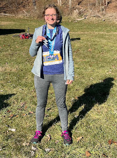 Me holding two medals at the end of the race.