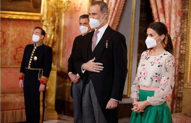 Queen Letizia wore a floral print blouse and green skirt. Queen Letizia is wearing her mother-in-law, Queen Sofia's blouse