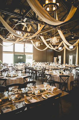 farm table wedding reception with cross back wooden chairs