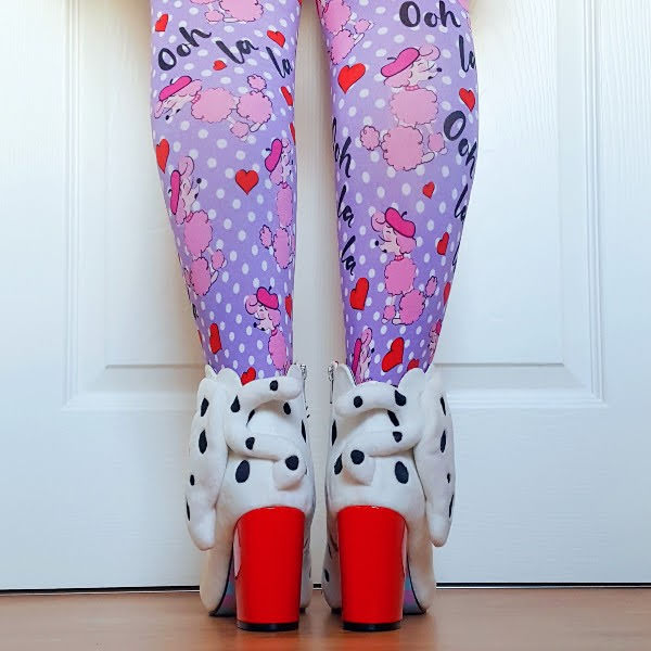 back view of legs in poodle print tights with white dog ankle boots with tail and red patent heels