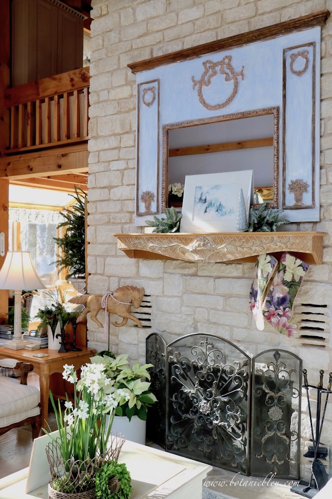 Artificial greenery and faux greenery blend well with live poinsettias, fresh greenery, and a tabletop fresh tree.